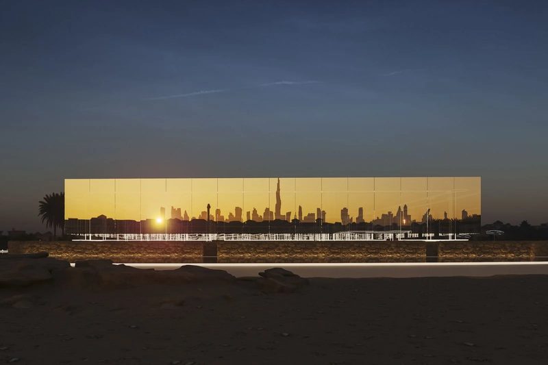 Jumeirah Archaeological Square · Jumeirah — the mirrored façade at sunset, the skyline reflected in it